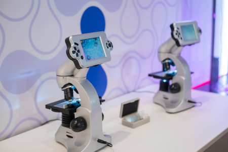 MOSCOW, RUSSIA - JANUARY 10, 2020: Healthcare Exhibition. Microscopes with display and control buttons on white table. Laboratory equipment, science, optical, pharmaceutical and education conceptのeditorial素材