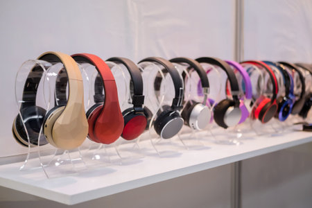 Colorful wireless headphones in row at electronic store, exhibition. Entertainment, technology, device, sale and multimedia conceptの写真素材