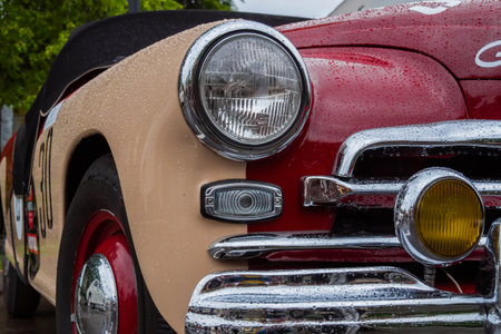 NIZHNY NOVGOROD, RUSSIA - JUNE 15, 2020: Classic Soviet Car Exhibition. Round headlight of vintage soviet car beige and red GAZ M20 Pobeda-Sport. Historical, retro, vintage and nostalgia conceptのeditorial素材