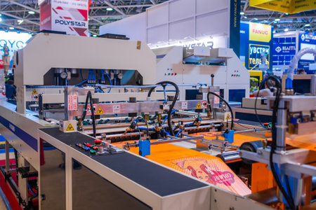 MOSCOW, RUSSIA - JUNE 05, 2019: Package exhibition. Fully automatic high speed shopping bag making machine with servo driving system at trade showのeditorial素材