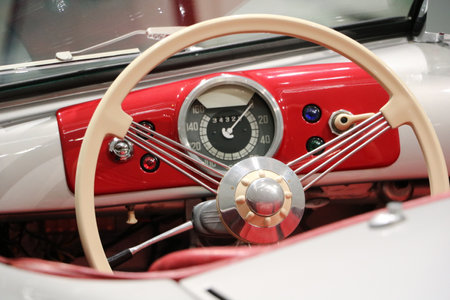 The dashboard of the antique car is visible. The photo shows the steering wheel and gauges of the car.の写真素材