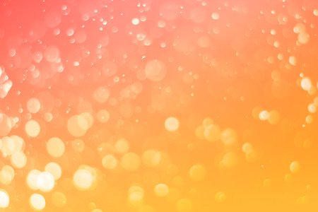 Abstract bokeh light on orange tone backgroundの写真素材