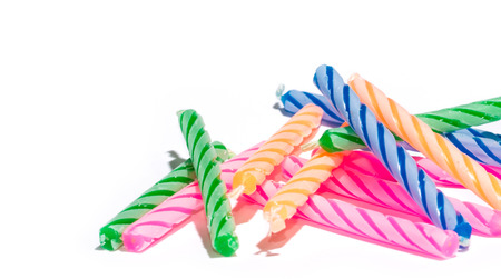 closeup colorful birthday candles isolated on whiteの写真素材