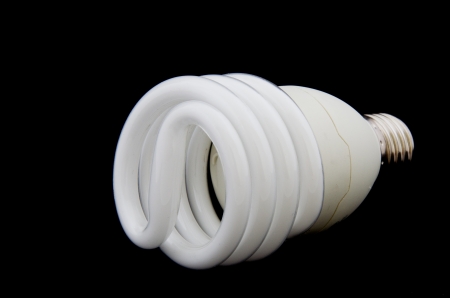 Spiral Energy saving flourescent bulb on black background. の写真素材