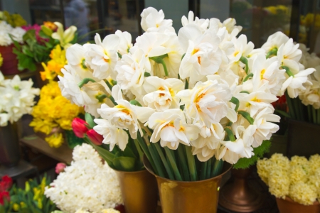 Vase with beautiful spring flowers on the streetの写真素材