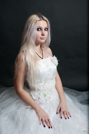 Beautiful girl in white dress on black backgroundの写真素材