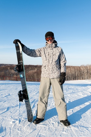 Snowboarder standing on a slopeの写真素材