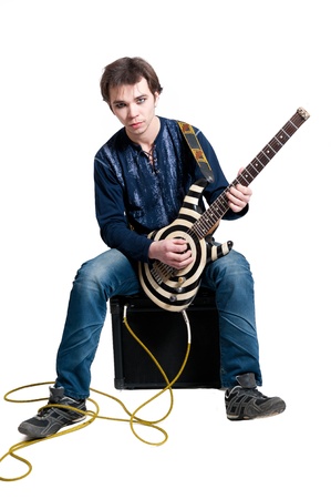 Young guitarist with electric guitar on white backgroundの写真素材