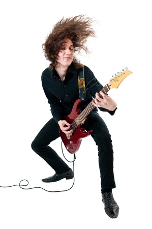 Young guitarist with red guitar on white backgroundの写真素材