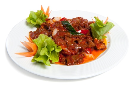 Roasted beef with vegetables on a plate isolated on whiteの写真素材