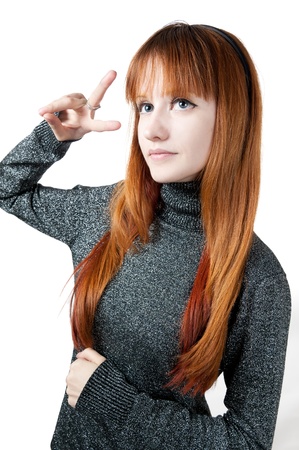 the beautiful girl with red long hair in a sweater isolated on whiteの写真素材