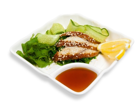 salad of warm smoked eel with pickled cucumbers and seaweed isolated on whiteの写真素材