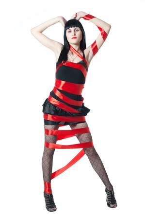 sexy women in black dress rolled up by a red ribbonの写真素材