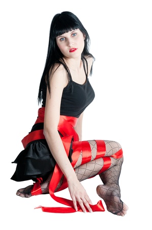 sexy women in black dress rolled up by a red ribbonの写真素材