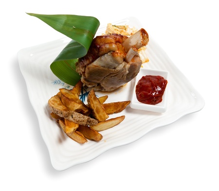 pork shank with potatoes and sauce isolated on white backgroundの写真素材