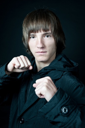 young man in the jacket on a black backgroundの写真素材