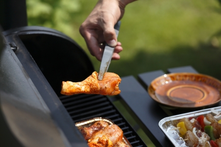 Juicy slices of meat with sauce prepare on fire の写真素材