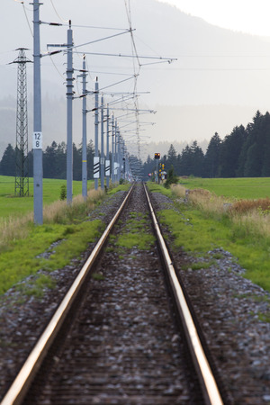 Railroad tracks in high mountains in spring seasonの写真素材