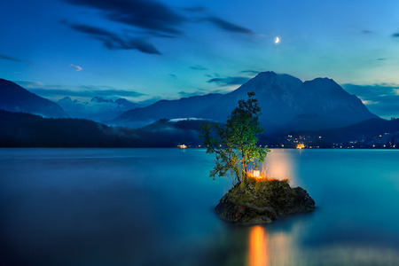 Small island on the lake in mountains Austriaの写真素材