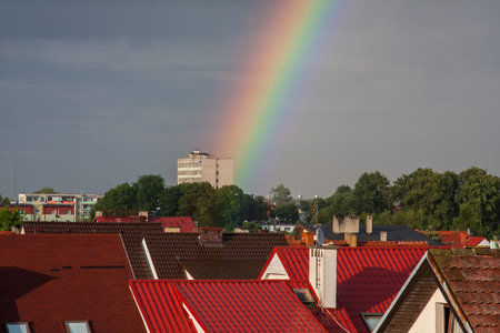 Beautiful rainbow over the city in summerの写真素材