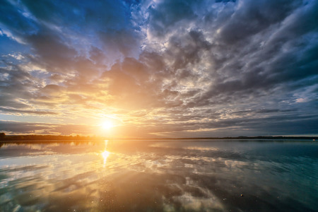 Beautiful sunset over the lake in mountainsの写真素材