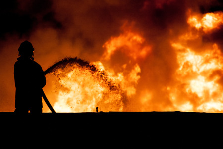 Fireman working in the night at the explosionの写真素材