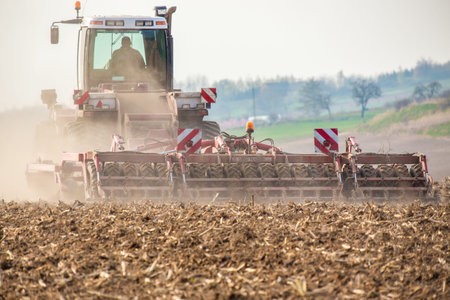 The tractor harvester working on the field