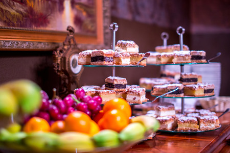 Many different cakes and fruits on the plateauの写真素材