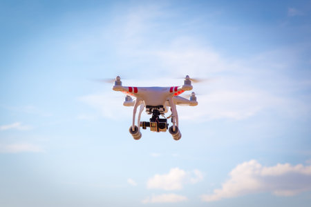 Modern drone flying high in the good weather