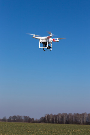 Small drone is flying with the blue sky in the backgroundの写真素材