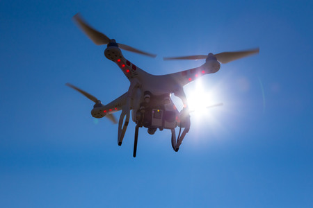 Small drone is flying with the blue sky in the backgroundの写真素材
