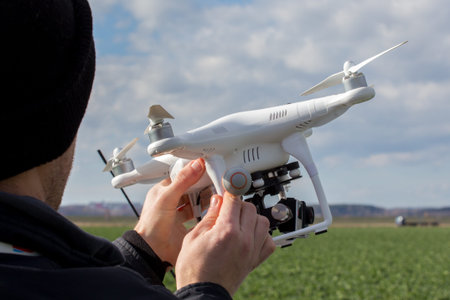 Human hands taking the small white drone