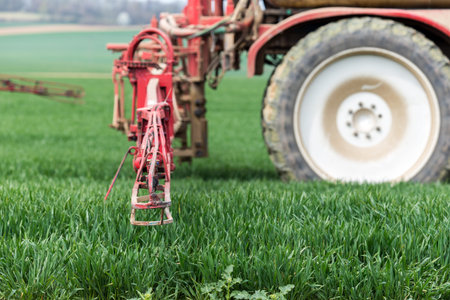 Spraying the herbicides on the green fieldの写真素材