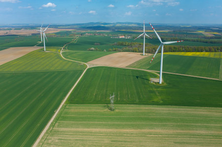 Aerial view on the windmills on the green field