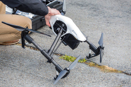 Human hand with small amateur modern drone