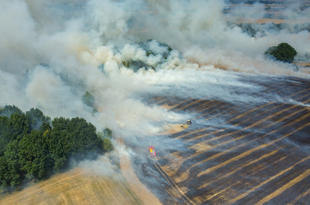 Big fire on the large wheat fieldの写真素材