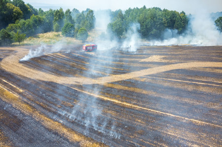 Aerial view on the fireman truck working on the field on fire