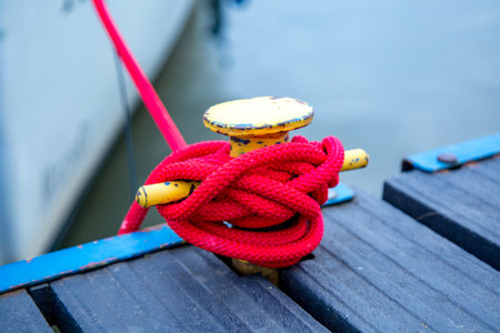 Knots on the rope on the bollard on the pierの写真素材