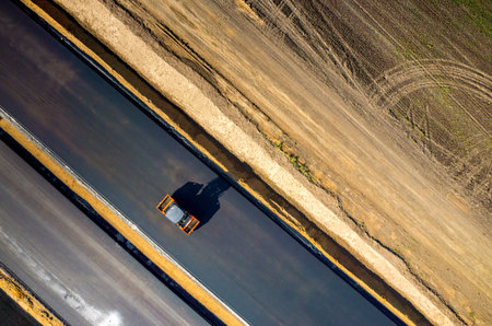 Aerial view on the new asphalt road under construction