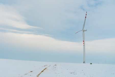 Large view on the windmill on the field in winter season