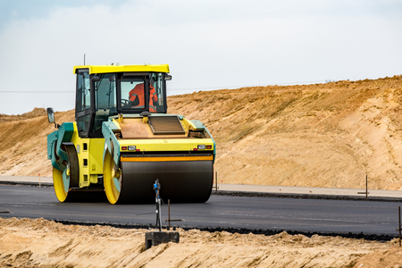Road roller building the new asphalt roadの写真素材