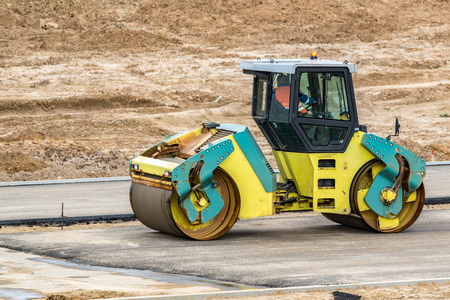 Road roller building the new asphalt roadの写真素材