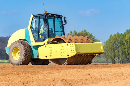 Large view on the compactor working on the new road construction site
