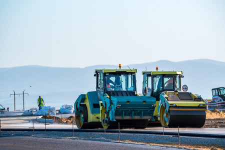 Large view on the road rollers working on the new road construction site