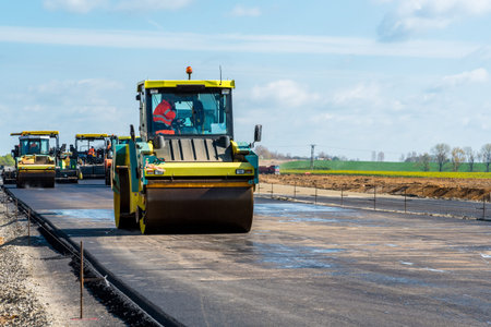 Large view on the road rollers working on the new road construction site