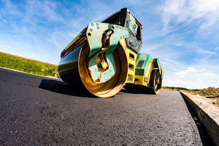 Close view on the road roller working on the new road construction site