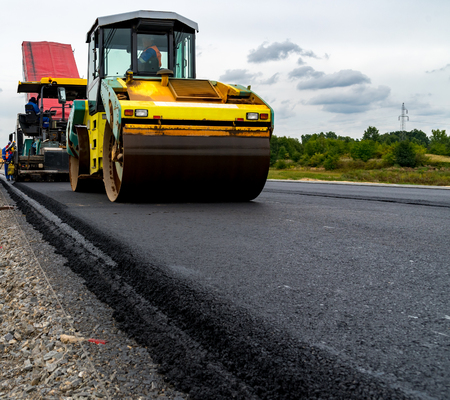 Large view on the road rollers working on the new road construction siteの写真素材