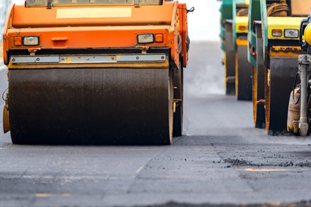Close view on the road rollers working on the new road construction site