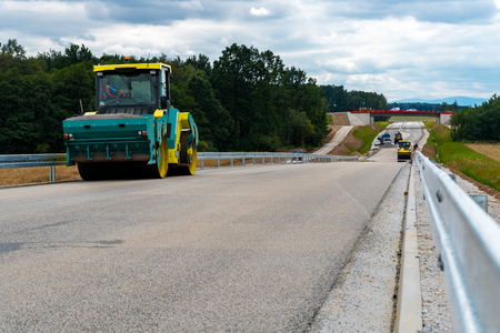 Close view on the road roller working on the new road construction siteの写真素材