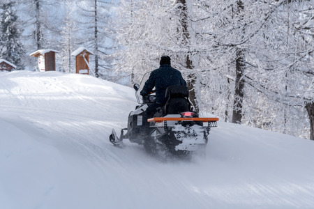 The scooter moving on the frozen road in the mountainsの写真素材